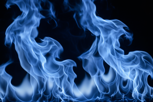 Generate me a very strong close closeup on a blue fire burning at night, all you can see is the fire flames
